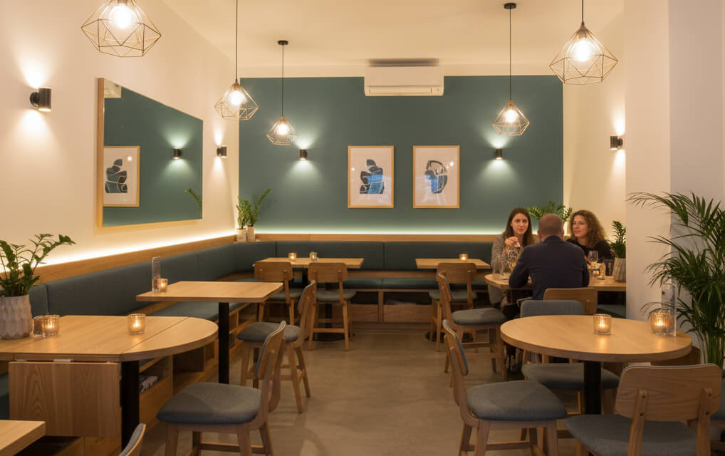 Compact restaurant interior with smart design, cozy lighting, and space-efficient seating that creates a welcoming atmosphere